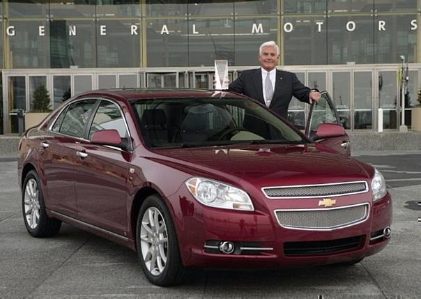 General Motors Vice Chairman Bob Lutz stands with the 2008 North American Car of the Year, the Chevrolet Malibu.